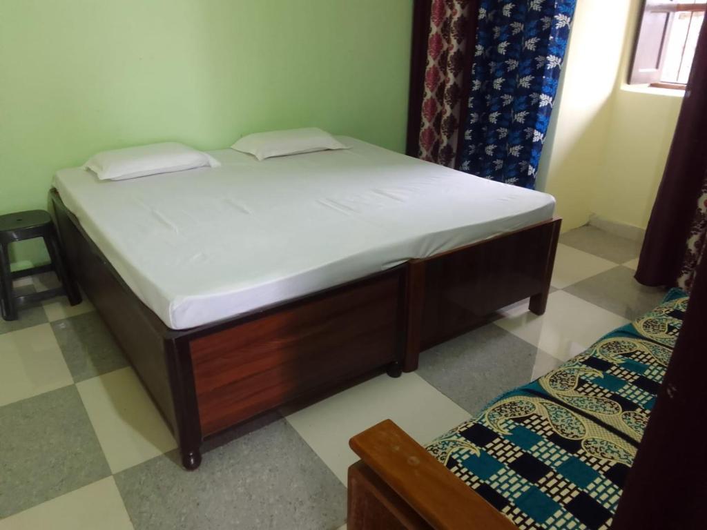 a bed in a room with a white mattress at Dev Bhoomi Home Stay in Marchula