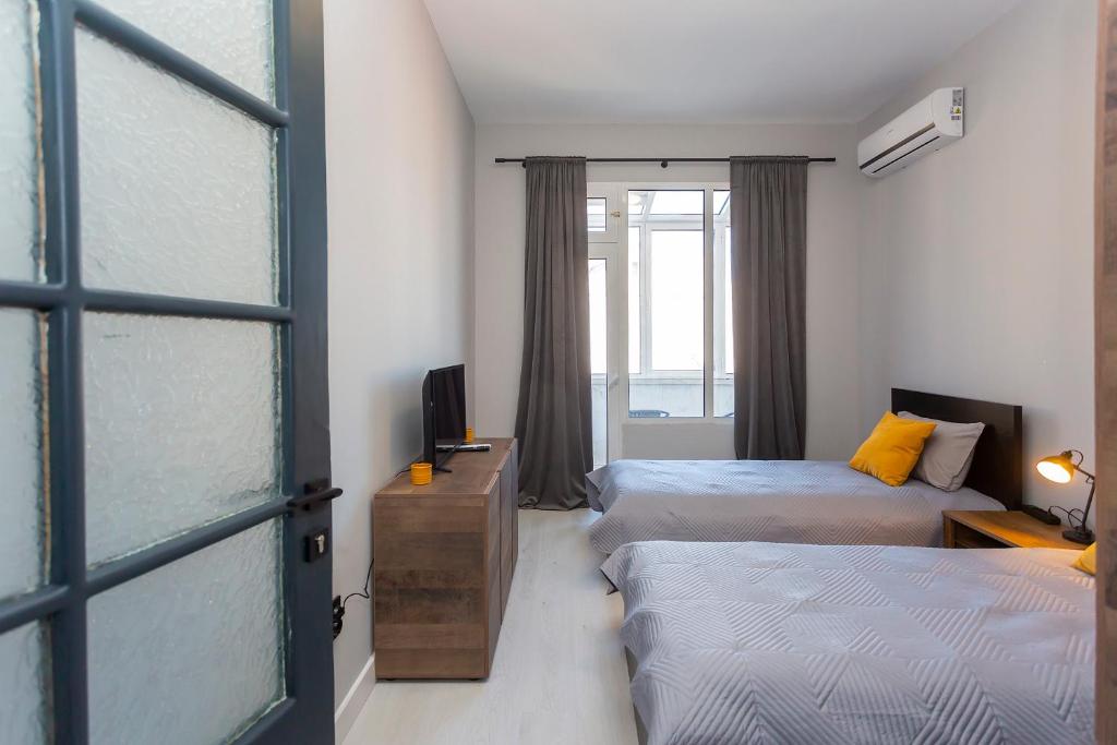 Postel nebo postele na pokoji v ubytování Urban Elegance Apartment