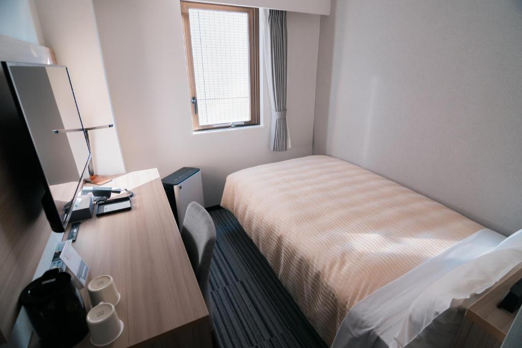 Postel nebo postele na pokoji v ubytování Quintessa Hotel Chiba Funabashi