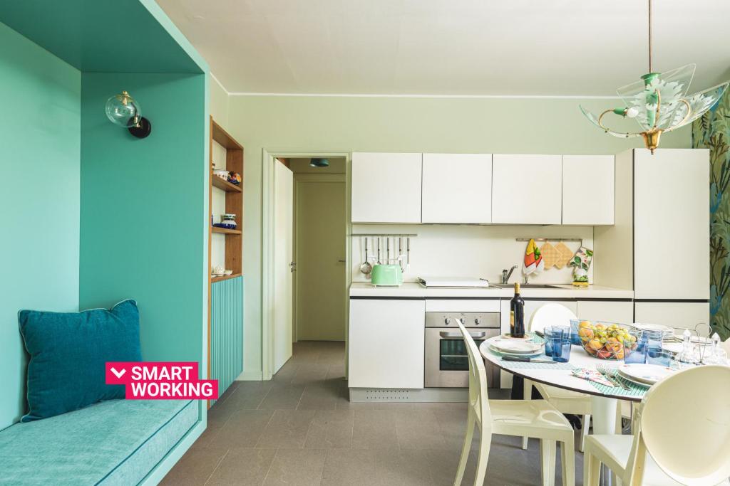 a kitchen and dining room with a table and chairs at Olga's Apartment a Mondello by Wonderful Italy in Mondello