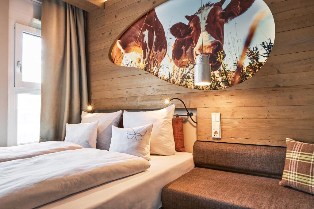 a bedroom with two beds and a mirror at Cocoon Hauptbahnhof in Munich