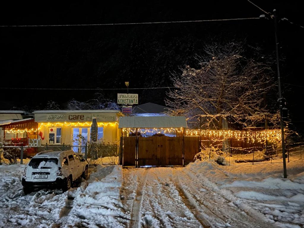 a car parked in front of a house with christmas lights at Konstanta in Lentekhi