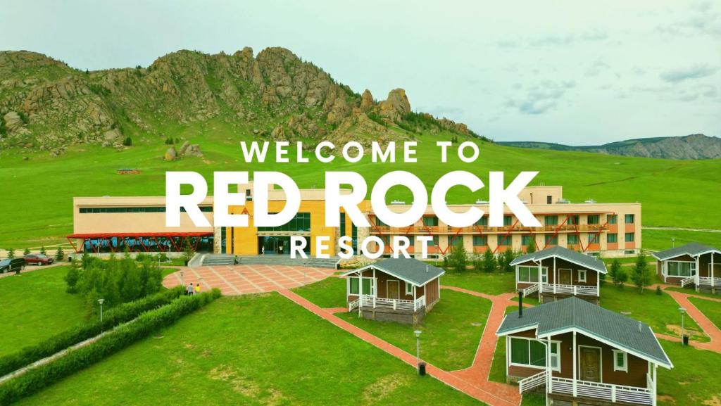 a red rock resort with a mountain in the background at Red Rock Resort in Ulaanbaatar