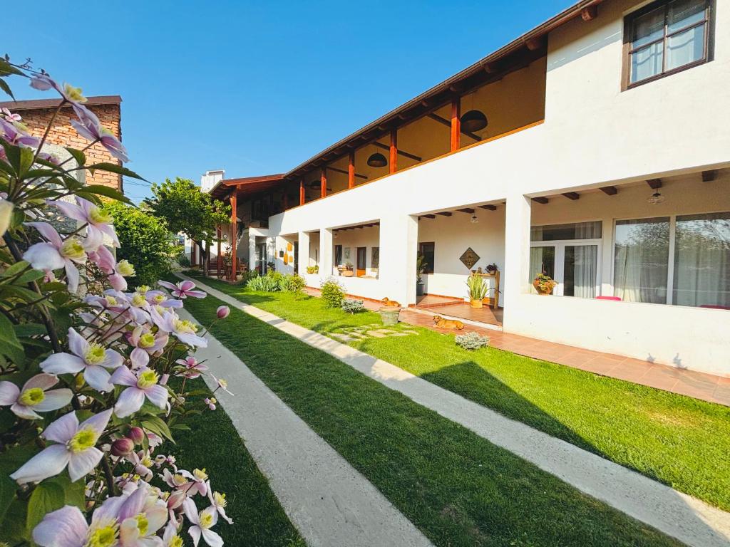 a courtyard of a building with grass and flowers at Elma Guesthouse in Alba Iulia