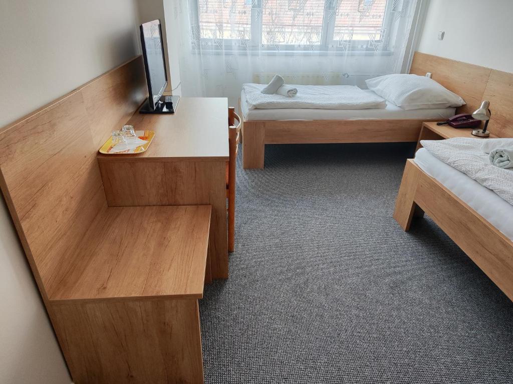 Postel nebo postele na pokoji v ubytování Hotel Panon