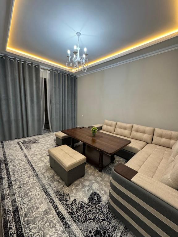 a living room with a couch and a table at City Plaza Zarhal in Samarkand