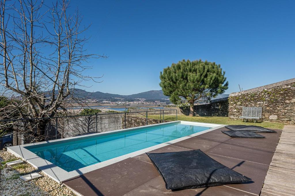 a swimming pool in front of a house at GuestReady - Lugar do Monte Seixas in Caminha