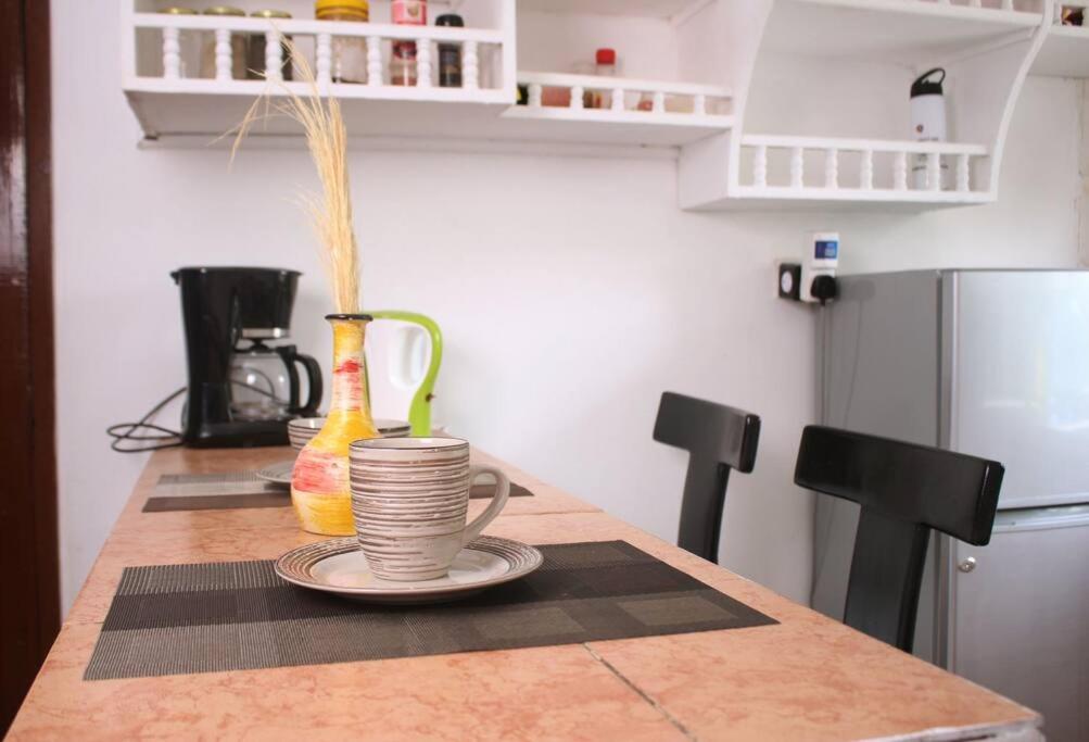 a kitchen with a table with a cup of spaghetti at Cozy escape in Karen in Nairobi