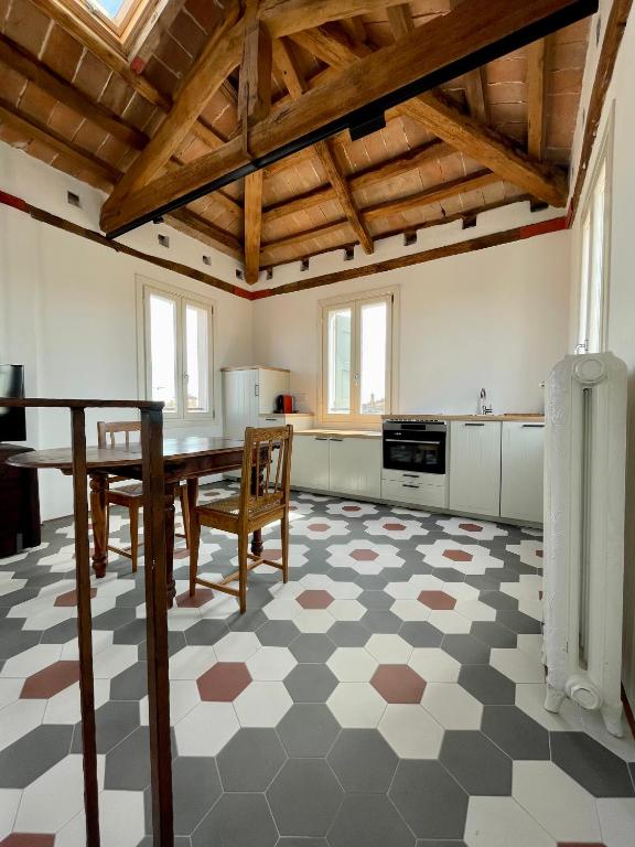 a kitchen with a table and chairs in a room at Altana della Ruggera in Modena