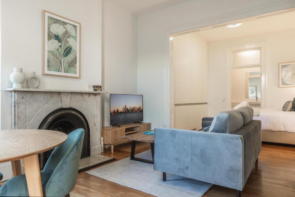 a living room with a couch and a fireplace at Modern 1-Bed Studio near Tramsheds in Sydney