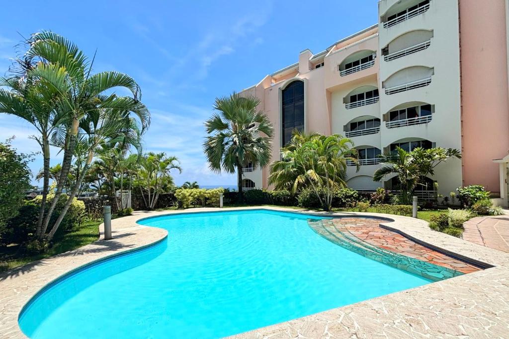 uma piscina em frente a um edifício em Duplex design sea view em Papeete