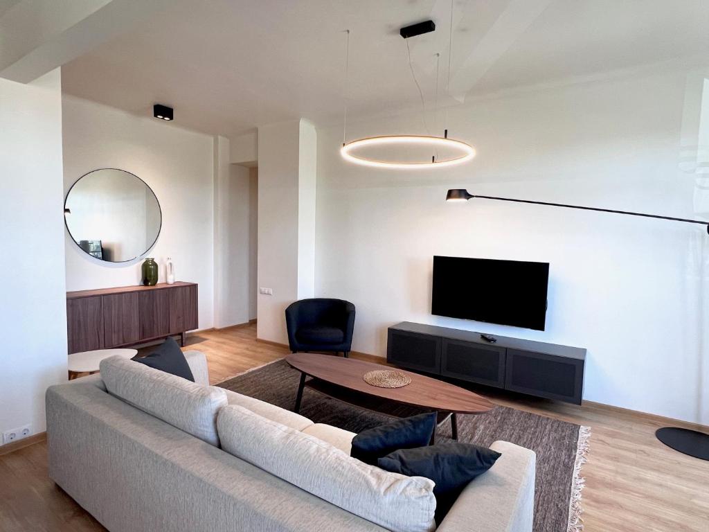 a living room with a couch and a tv at Vilnius Apartments & Suites – Old Town in Vilnius