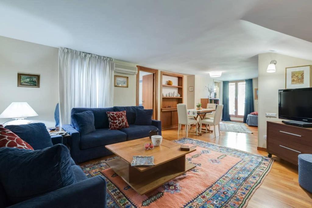 a living room with a blue couch and a table at Le Petite Resort B&B in Rome