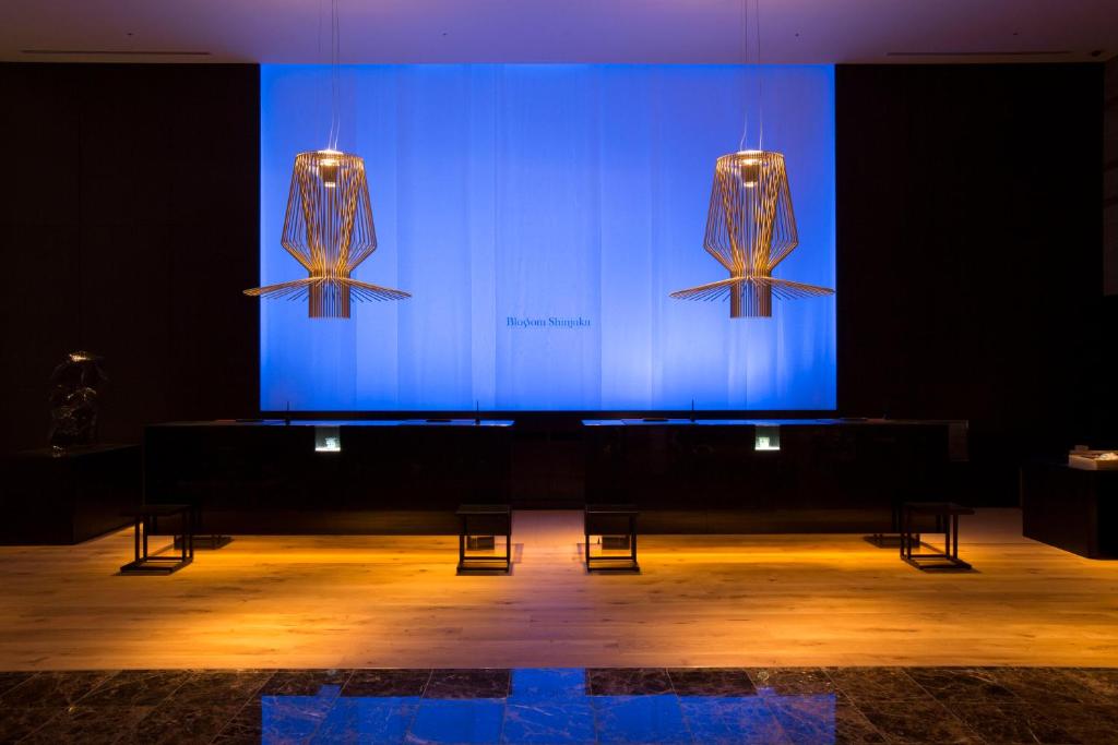 a large stage with two lights on a blue screen at JR Kyushu Hotel Blossom Shinjuku in Tokyo