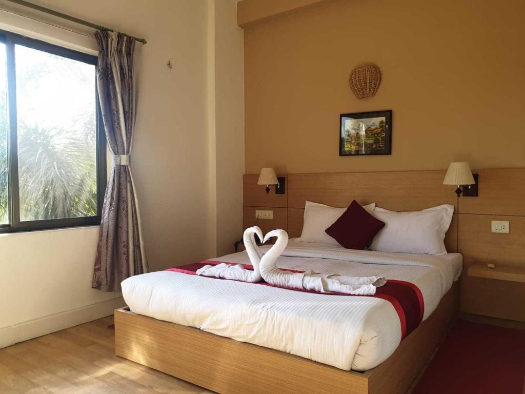 Postel nebo postele na pokoji v ubytování Hotel Ananda Inn
