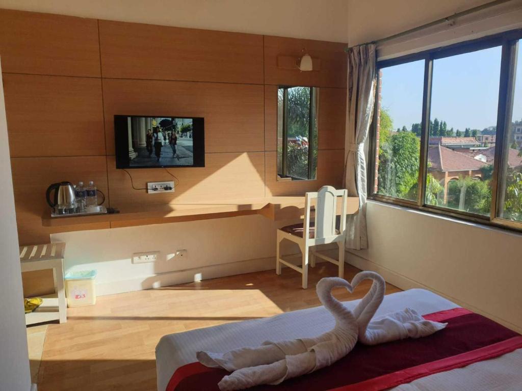 Postel nebo postele na pokoji v ubytování Hotel Ananda Inn