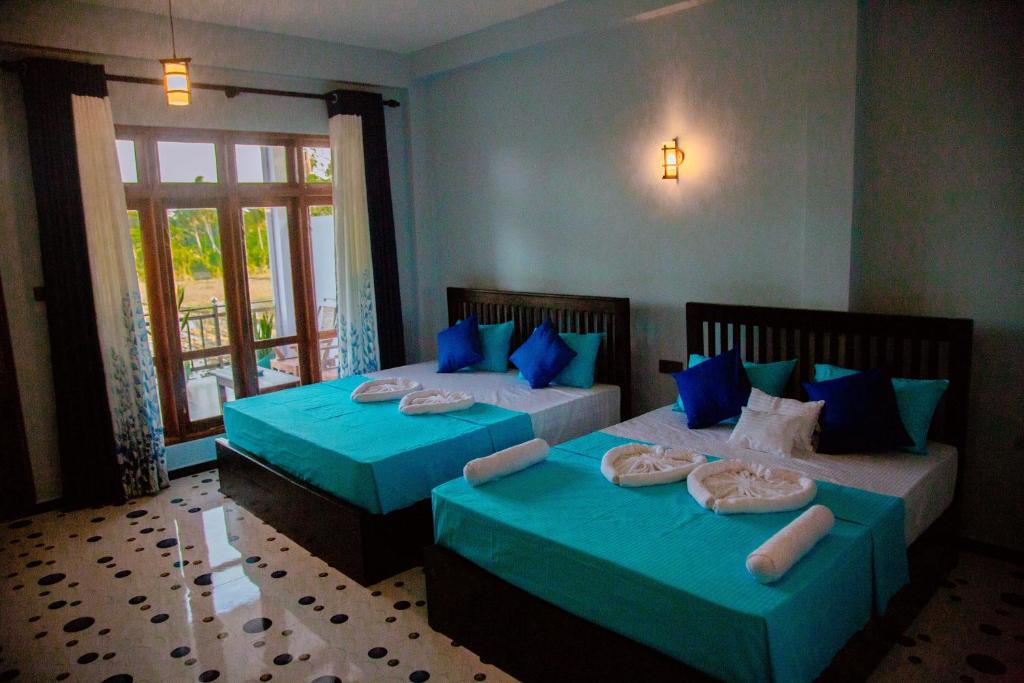 Postel nebo postele na pokoji v ubytování My Resort Yala