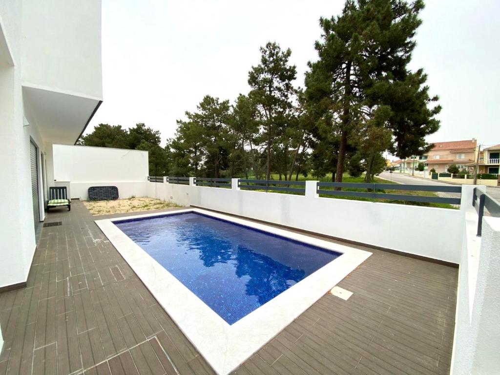 a swimming pool on a balcony of a house at Luxury villa surrounded by nature and beach in Amora