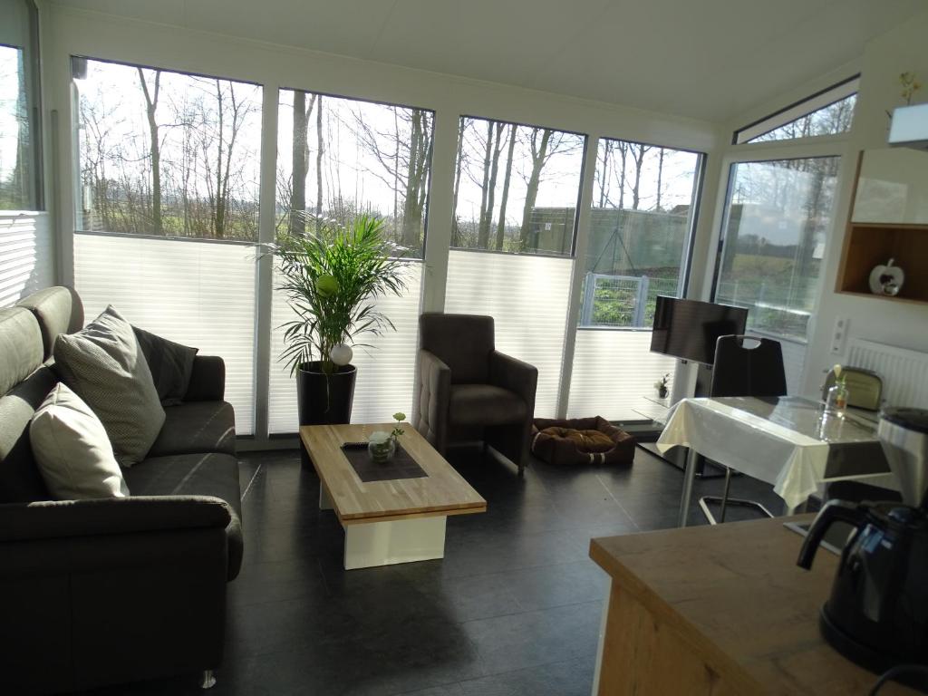 a living room with a couch and a table at Ferienapartment Birkenhain in Wettringen