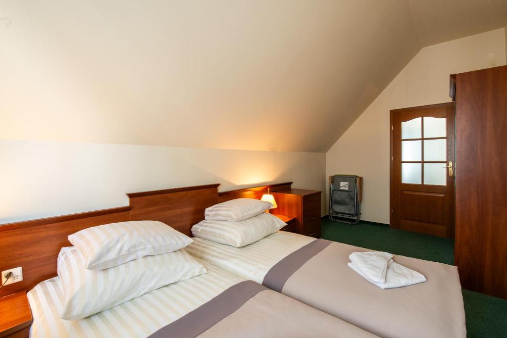 a bedroom with a bed with two pillows on it at Rewita Międzyzdroje - Galeon in Międzyzdroje