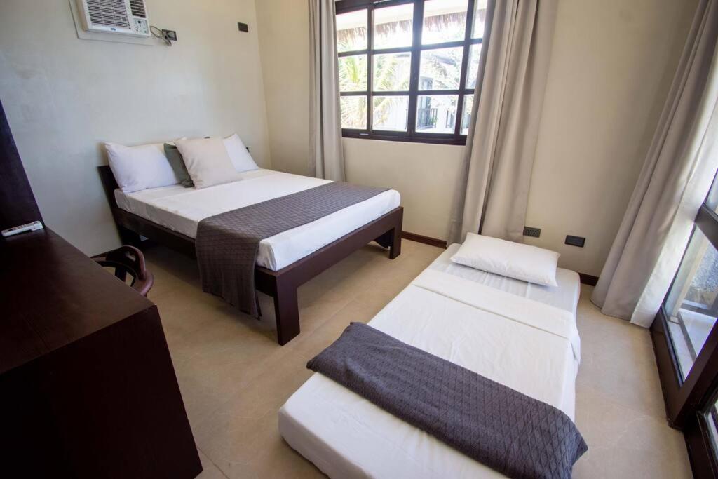 Voodi või voodid majutusasutuse Hey Jude Bulabog Beachfront Residence toas
