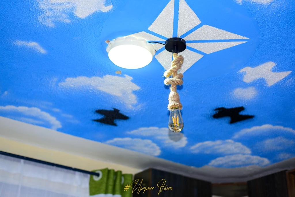 a ceiling with a star and a lamp with stars on it at Upper Haven Apartment in Kakamega