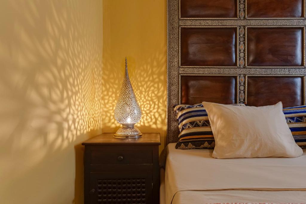 a bedroom with a bed and a lamp on a night stand at Casa da Moura in Lagos