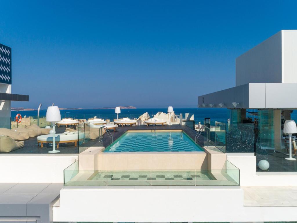 a swimming pool on the side of a building at Amàre Beach Hotel Ibiza - Adults Recommended in San Antonio Bay