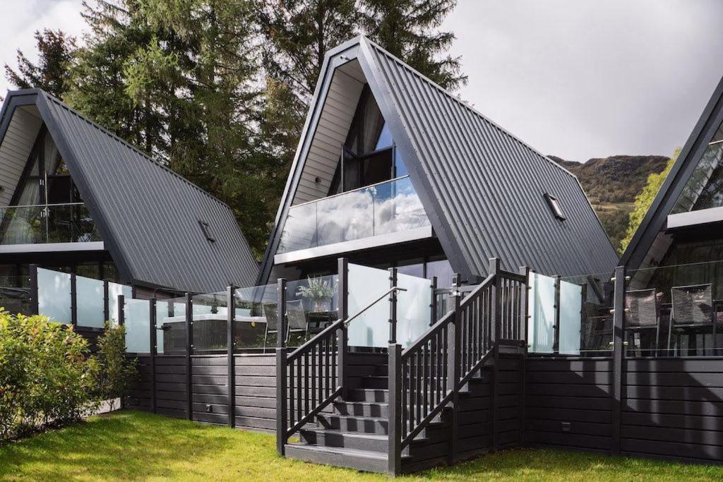 a house with a staircase in front of it at Ardlui Retreat Lodge 7 in Arrochar