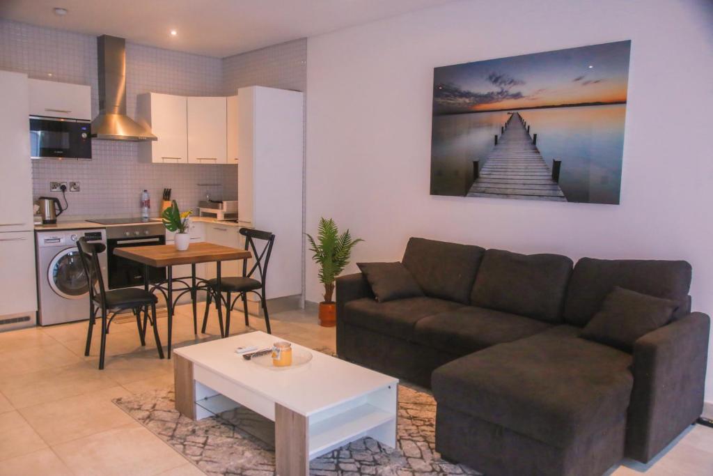 a living room with a couch and a table at Bark Luxury Apartments @The Signature in Accra