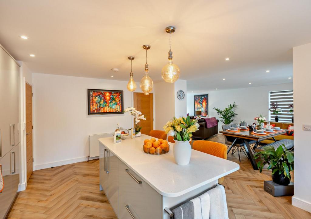 a kitchen and living room with a table with oranges at Greenacres in Chittlehampton