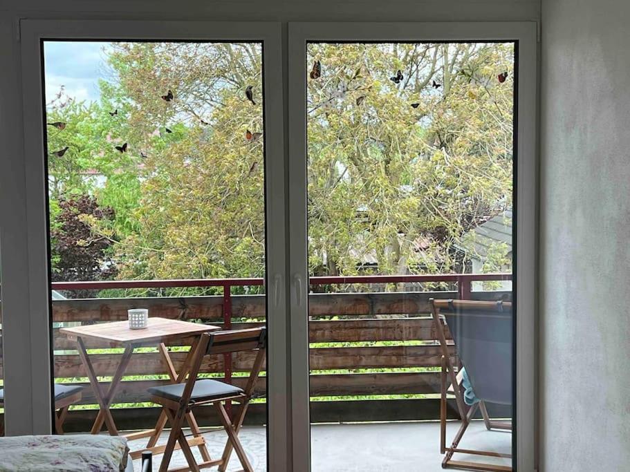 a balcony with a table and chairs and a window at Ferienwohnung Saumpfad 25 Min ins Legoland in Horgau