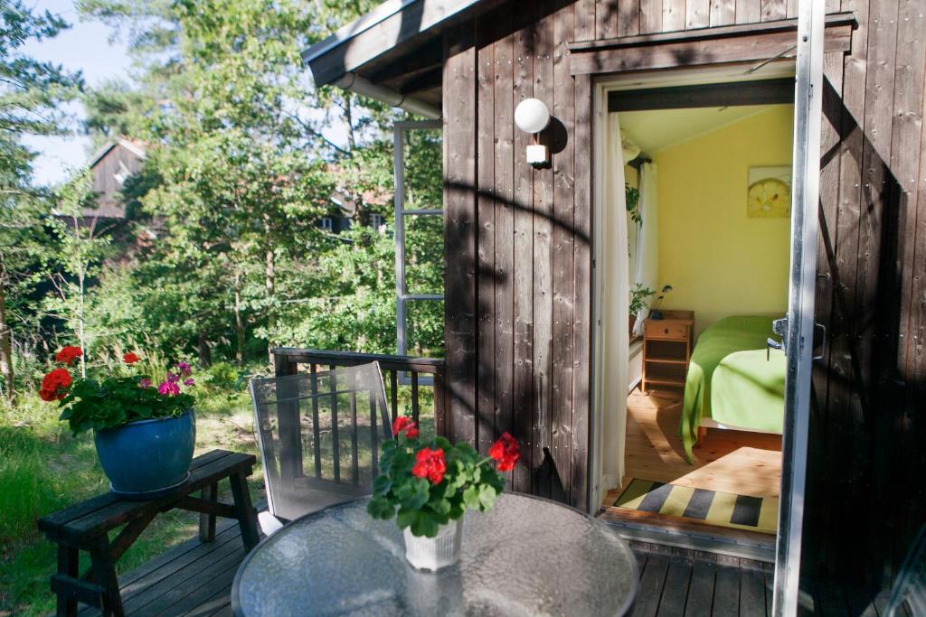 a patio with a table and a bed in a shed at B&B Eco-Village 12 min from city in Stockholm