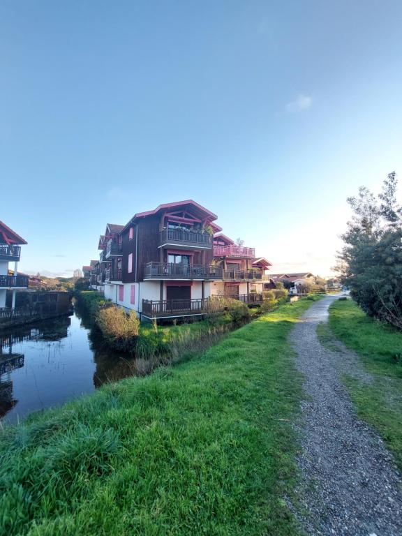 Une rangée de maisons près d'une rivière dans l'établissement Bel appartement 2 pièces proche Arcachon, plage et port, à La Teste-de-Buch