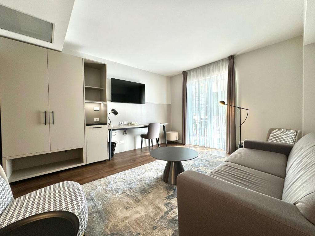 a living room with a couch and a table at Hotel Marina in Izola