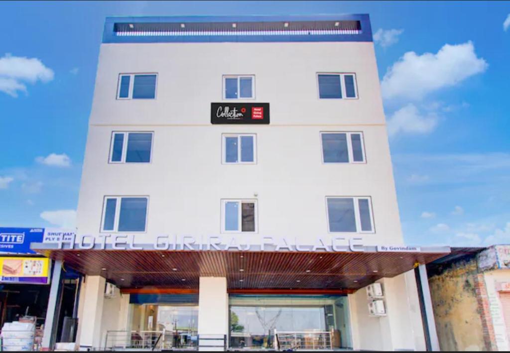a white building with a sign on top of it at Hotel Giriraj Palace in Jaipur