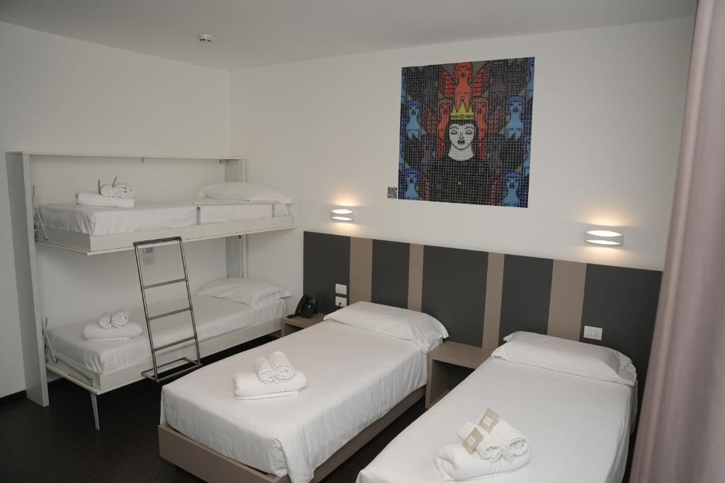 Postel nebo postele na pokoji v ubytování HOTEL MOSAICO