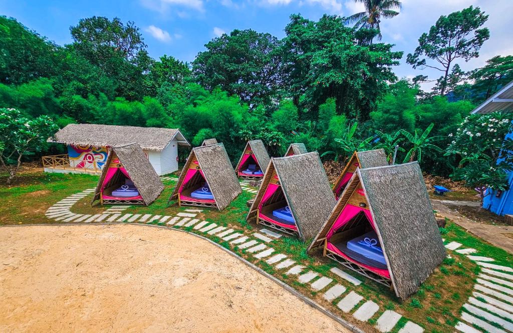 a group of little play tents in the grass at Slumber Resort Koh Chang in Trat