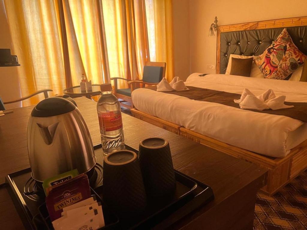 a hotel room with a bed and a blender at Guza Ethnic Resort in Leh