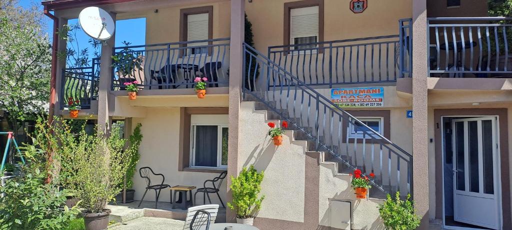 a building with stairs leading to a balcony with plants at Studio Kaća 2 in Cetinje