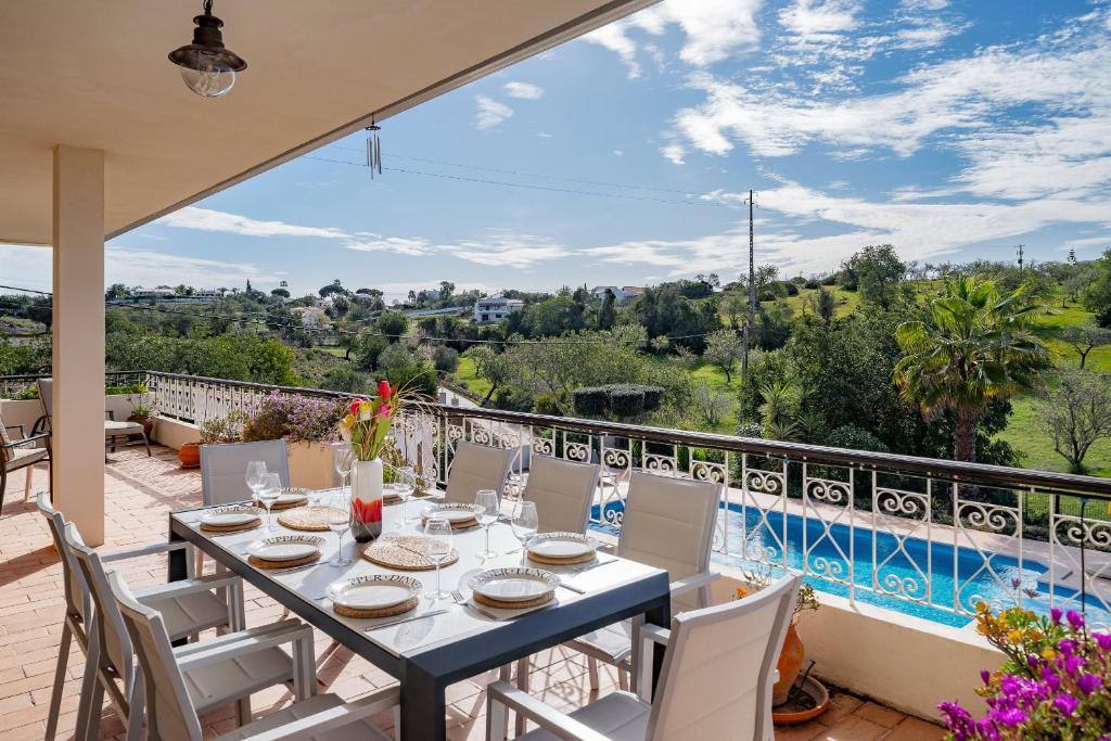a dining room with a table and chairs on a balcony at Family Holiday Villa with Pool in Albufeira
