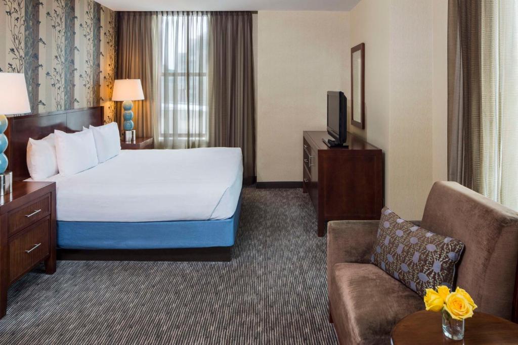 une chambre d'hôtel avec un lit et un canapé dans l'établissement Hyatt Regency Buffalo, à Buffalo