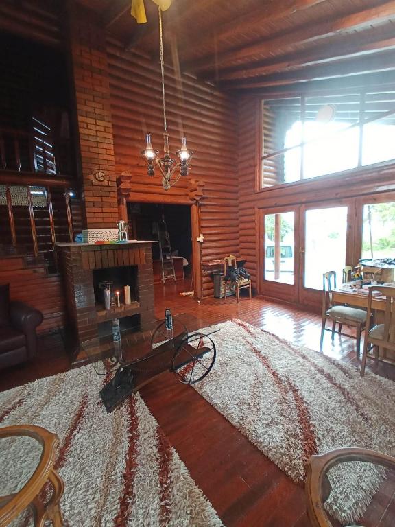a living room with a fireplace and a table and chairs at Chalet's lake_Bolu Abant _log house in Piroğlu