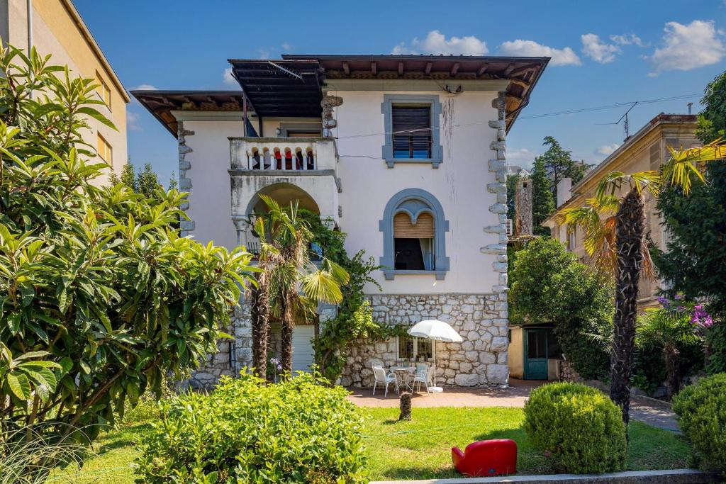 a house with a garden in front of it at City Apartment With Garden - Happy Rentals in Rijeka