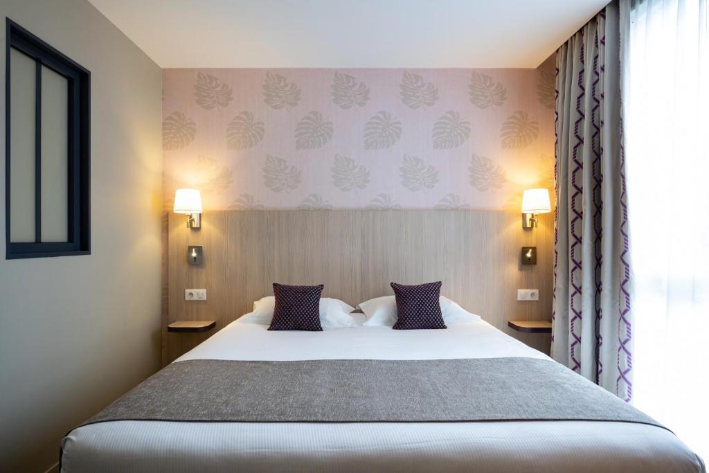 Postel nebo postele na pokoji v ubytování Kyriad Prestige Saint-Malo