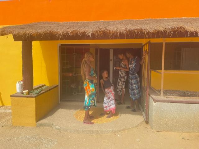 a group of people standing in a play house at KEUR Junior in Ndangane