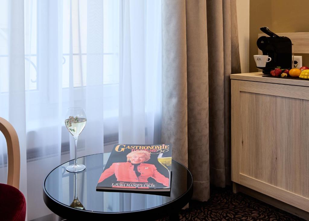 a book sitting on a glass table next to a window at Hotel St.Gotthard in Zürich
