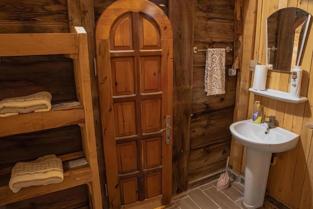 a bathroom with a sink and a toilet in a cabin at Heredot's house in Finike