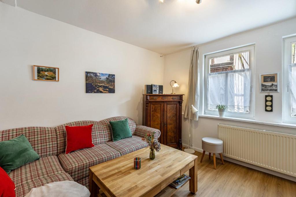 a living room with a couch and a table at Ferienhaus Bodebaude in Thale