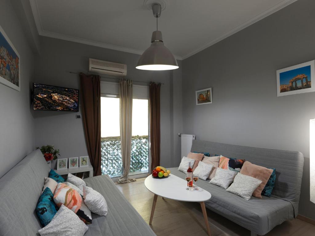 a living room with a couch and a table at The Acropolis Apartment in Athens